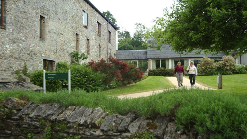 Two people walking in a garden